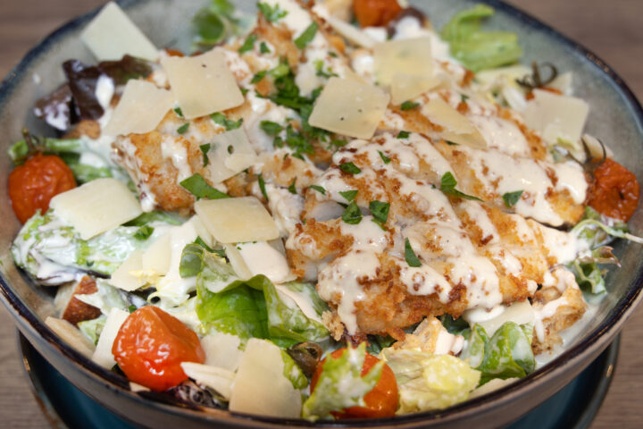 Le Bouchon des Artistes' Caesar salad with Viennese-style chicken fillets, Parmesan shavings and candied cherry tomatoes, Caesar dressing